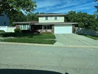 9700 Hardesty Ave, Kansas City, MO 64137 - view of front of home with driveway and an attached garage