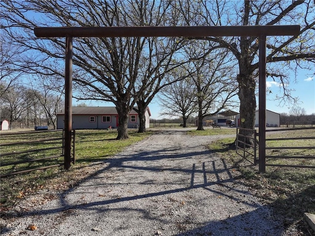 6721 S Read Rd Unit 1, Pleasanton, KS 66075 - view of dirt / gravel road with a gated entry