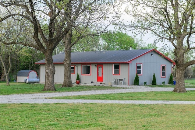 6721 S Read Rd Unit 1, Pleasanton, KS 66075 - ranch-style home featuring a shed, a front lawn, metal roof, and an outdoor structure
