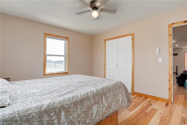 6721 S Read Rd Unit 1, Pleasanton, KS 66075 - bedroom featuring light wood-style floors, a closet, baseboards, and a ceiling fan