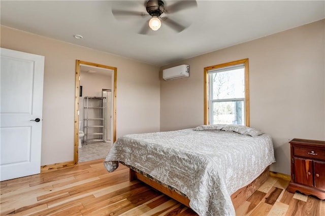 6721 S Read Rd Unit 1, Pleasanton, KS 66075 - bedroom with a wall mounted AC, light wood finished floors, and ceiling fan