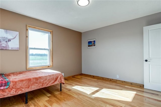 6721 S Read Rd Unit 1, Pleasanton, KS 66075 - bedroom with light wood-type flooring and baseboards