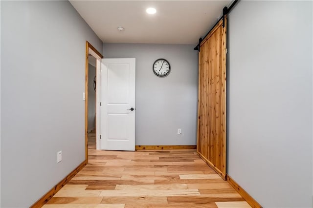 6721 S Read Rd Unit 1, Pleasanton, KS 66075 - hall featuring baseboards, light wood finished floors, a barn door, and recessed lighting