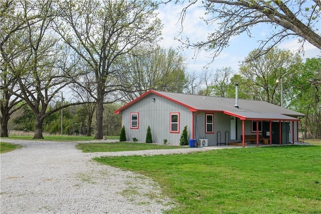 6721 S Read Rd Unit 1, Pleasanton, KS 66075 - back of house with a yard, driveway, and board and batten siding