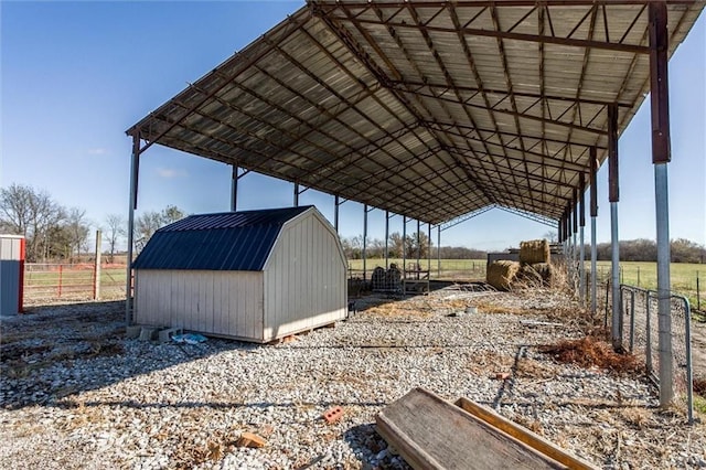 6721 S Read Rd Unit 1, Pleasanton, KS 66075 - view of shed featuring a carport, a view of countryside, and fence