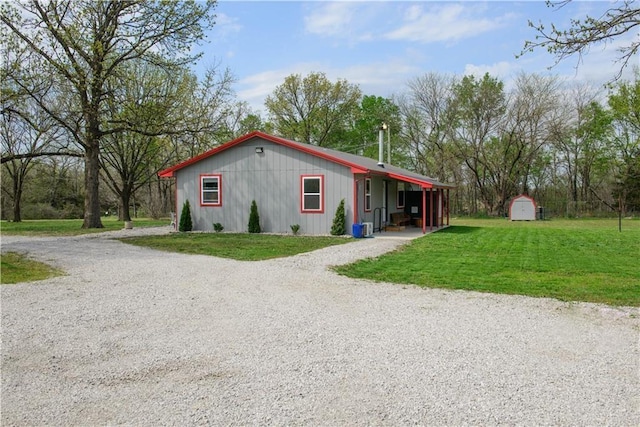 6721 S Read Rd Unit 1, Pleasanton, KS 66075 - view of front of home featuring gravel driveway, an outbuilding, a storage shed, and a front yard
