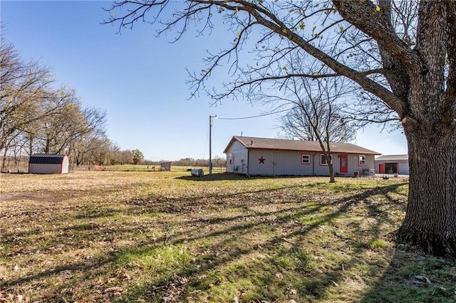 6721 S Read Rd Unit 1, Pleasanton, KS 66075 - view of green lawn featuring an outdoor structure and a storage unit
