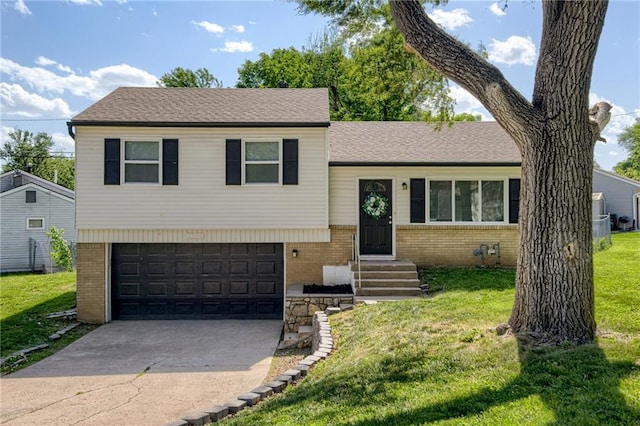 3200 Queen Ridge Dr, Independence, MO 64055 - tri-level home with brick siding, a front yard, an attached garage, and concrete driveway