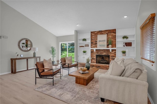 14 Woodbridge Ln, Kansas City, MO 64145 - living area with baseboards, healthy amount of natural light, vaulted ceiling, wood finished floors, and a brick fireplace