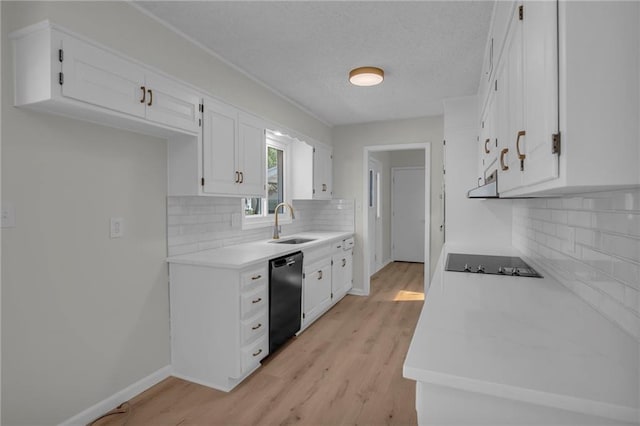 14 Woodbridge Ln, Kansas City, MO 64145 - kitchen with black appliances, a sink, white cabinetry, light countertops, and a textured ceiling