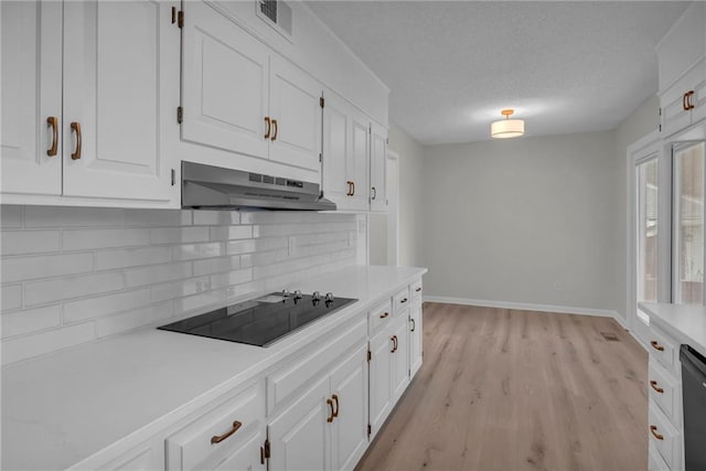 14 Woodbridge Ln, Kansas City, MO 64145 - kitchen featuring under cabinet range hood, black appliances, decorative backsplash, light countertops, and white cabinets