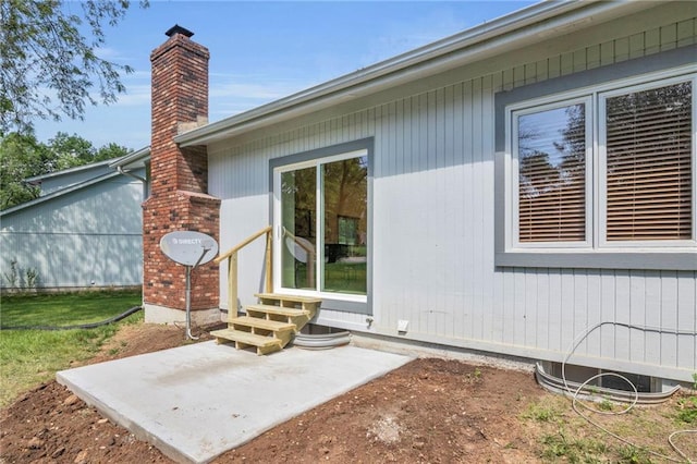 14 Woodbridge Ln, Kansas City, MO 64145 - doorway to property with a chimney and a patio area