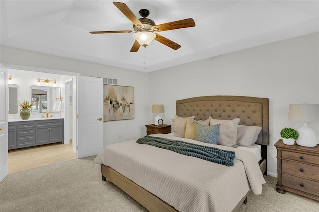 14 Woodbridge Ln, Kansas City, MO 64145 - bedroom with light colored carpet, ceiling fan, and connected bathroom