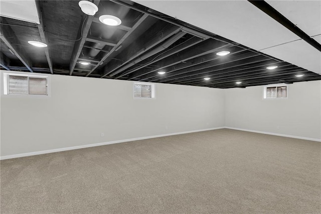 14 Woodbridge Ln, Kansas City, MO 64145 - basement featuring carpet flooring, plenty of natural light, and baseboards
