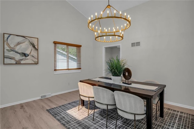 14 Woodbridge Ln, Kansas City, MO 64145 - dining room featuring a chandelier, high vaulted ceiling, wood finished floors, and baseboards