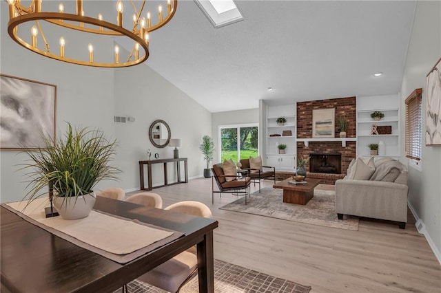 14 Woodbridge Ln, Kansas City, MO 64145 - living area featuring a fireplace, baseboards, light wood-style floors, a skylight, and high vaulted ceiling
