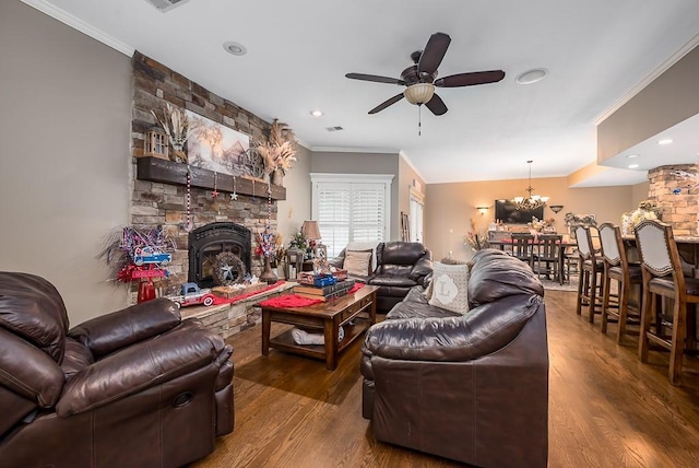 9500 Georgia Ave, Kansas City, KS 66109 - living area featuring crown molding, wood finished floors, ceiling fan, a chandelier, and a fireplace