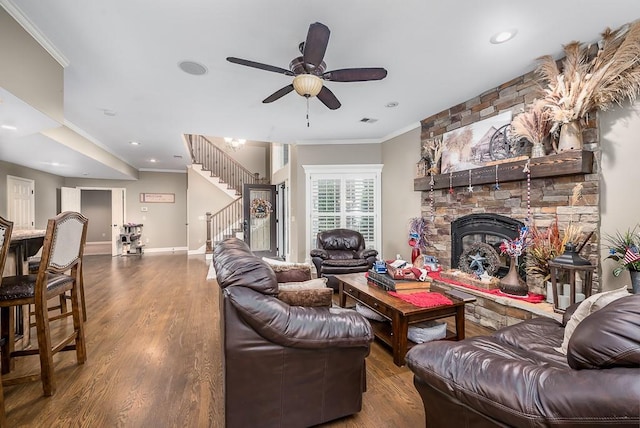 9500 Georgia Ave, Kansas City, KS 66109 - living room featuring stairway, ornamental molding, wood finished floors, a stone fireplace, and ceiling fan