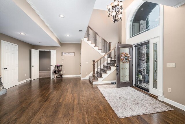 9500 Georgia Ave, Kansas City, KS 66109 - entryway with stairway, wood finished floors, baseboards, a chandelier, and crown molding