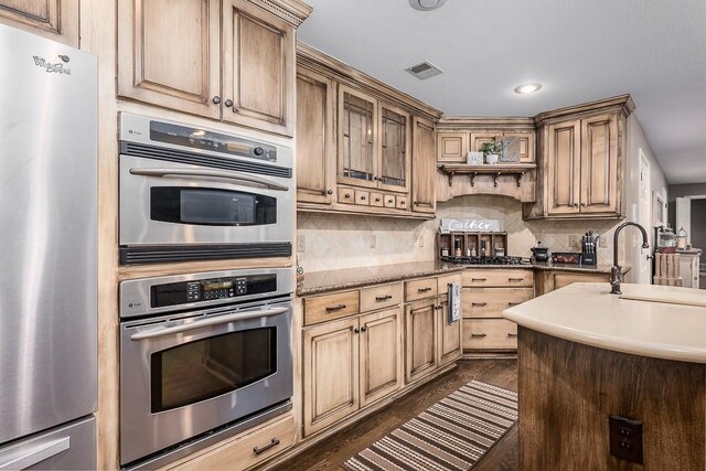 9500 Georgia Ave, Kansas City, KS 66109 - kitchen with appliances with stainless steel finishes, a sink, recessed lighting, and decorative backsplash