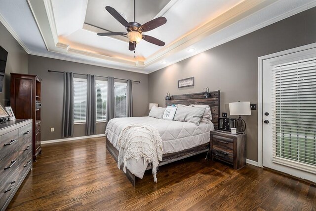 9500 Georgia Ave, Kansas City, KS 66109 - bedroom featuring a tray ceiling, crown molding, dark wood-style flooring, baseboards, and ceiling fan