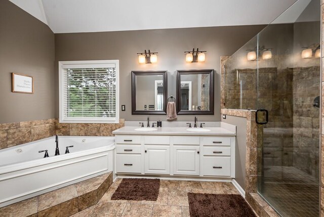9500 Georgia Ave, Kansas City, KS 66109 - full bathroom featuring a stall shower, a garden tub, double vanity, and vaulted ceiling