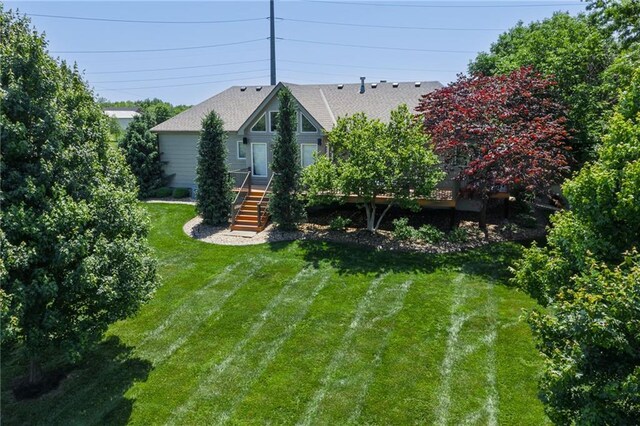 9500 Georgia Ave, Kansas City, KS 66109 - view of front facade featuring a front lawn, stairway, and roof with shingles