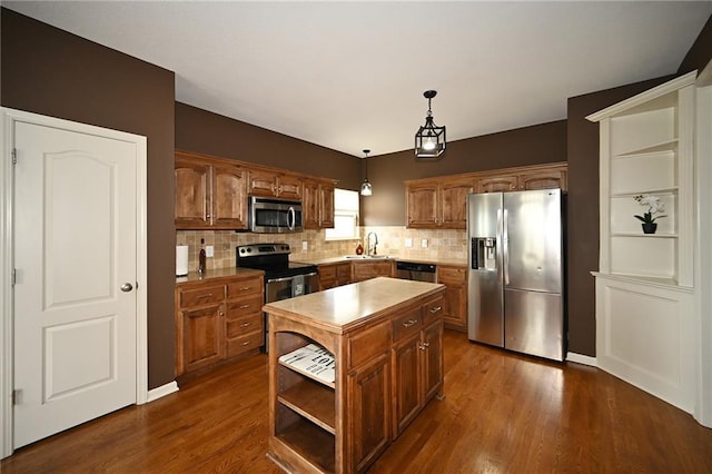 8941 NE 116th Pl, Kansas City, MO 64157 - kitchen with appliances with stainless steel finishes, a sink, a center island, tasteful backsplash, and dark wood finished floors