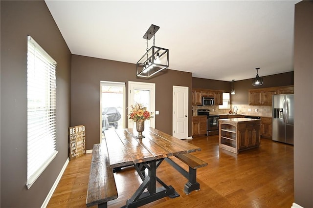 8941 NE 116th Pl, Kansas City, MO 64157 - dining area featuring plenty of natural light, wood finished floors, and baseboards