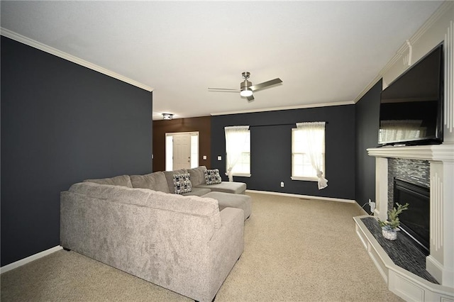 8941 NE 116th Pl, Kansas City, MO 64157 - carpeted living room featuring ceiling fan, a fireplace, baseboards, and ornamental molding