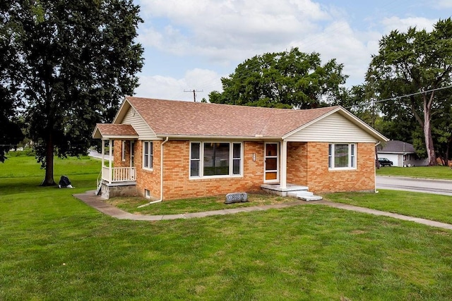911 Limit St, Leavenworth, KS 66048 - view of front facade with brick siding, a front lawn, and a shingled roof