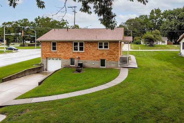 911 Limit St, Leavenworth, KS 66048 - rear view of property with driveway, an attached garage, a lawn, and brick siding
