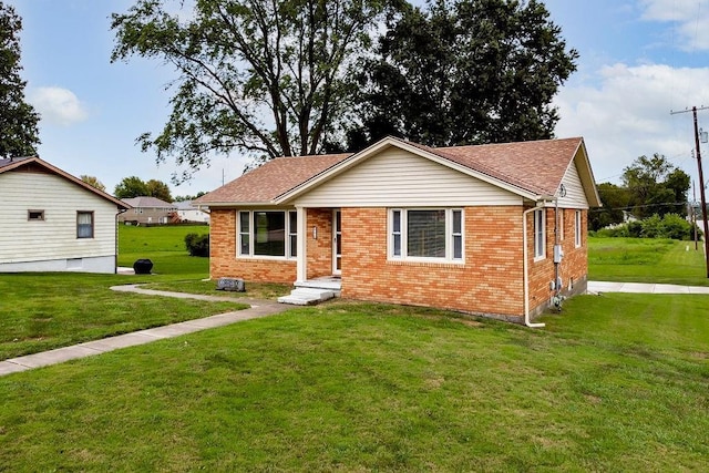 911 Limit St, Leavenworth, KS 66048 - view of front facade with brick siding, a front lawn, and roof with shingles