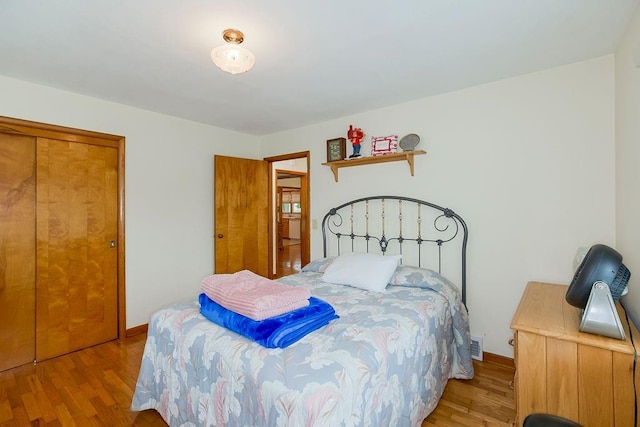 911 Limit St, Leavenworth, KS 66048 - bedroom with light wood-type flooring, baseboards, and a closet