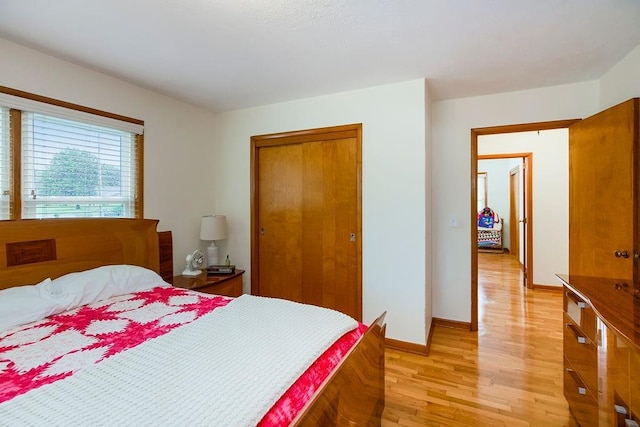 911 Limit St, Leavenworth, KS 66048 - bedroom with light wood-style floors, a closet, and baseboards