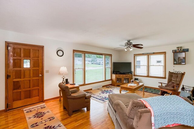 911 Limit St, Leavenworth, KS 66048 - living room with light wood finished floors, ceiling fan, and baseboards
