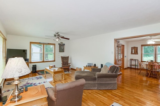 911 Limit St, Leavenworth, KS 66048 - living room with a ceiling fan, light wood-type flooring, and baseboards