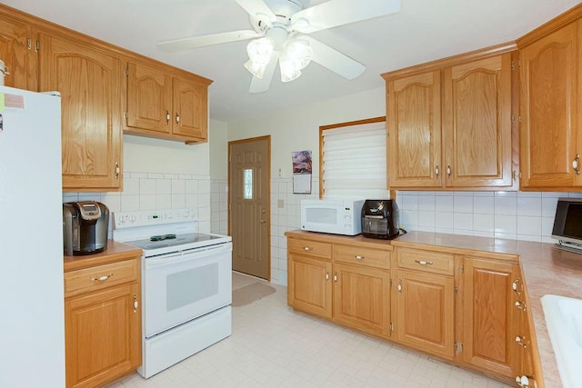 911 Limit St, Leavenworth, KS 66048 - kitchen with white appliances, ceiling fan, light countertops, and decorative backsplash