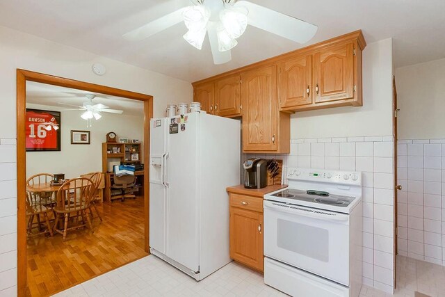 911 Limit St, Leavenworth, KS 66048 - kitchen featuring white appliances, a ceiling fan, and light countertops