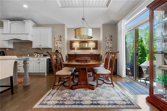 dining room with dark wood-style flooring, wine cooler, and recessed lighting