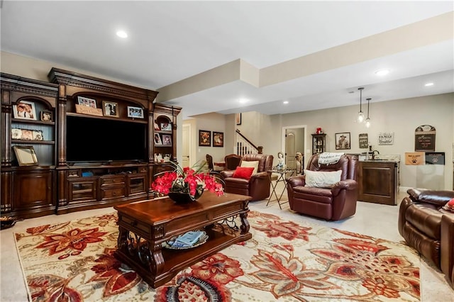 living room with stairway and recessed lighting