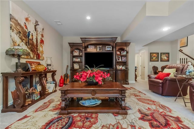living area featuring light carpet and recessed lighting