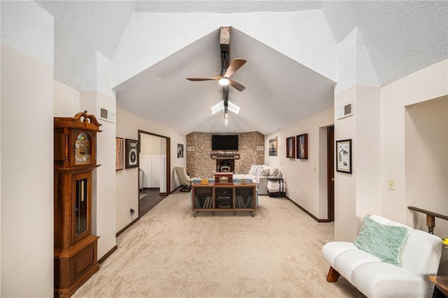 2018 Park Ln, Smithville, MO 64089 - dining area featuring a brick fireplace, ceiling fan, vaulted ceiling, light carpet, and baseboards