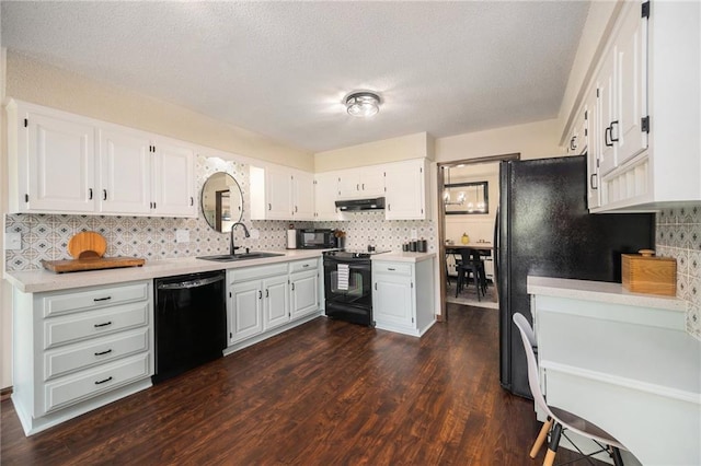 2018 Park Ln, Smithville, MO 64089 - kitchen with black appliances, a sink, under cabinet range hood, light countertops, and white cabinets
