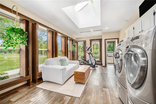 2018 Park Ln, Smithville, MO 64089 - laundry room featuring washing machine and dryer, plenty of natural light, a skylight, light wood-style floors, and recessed lighting