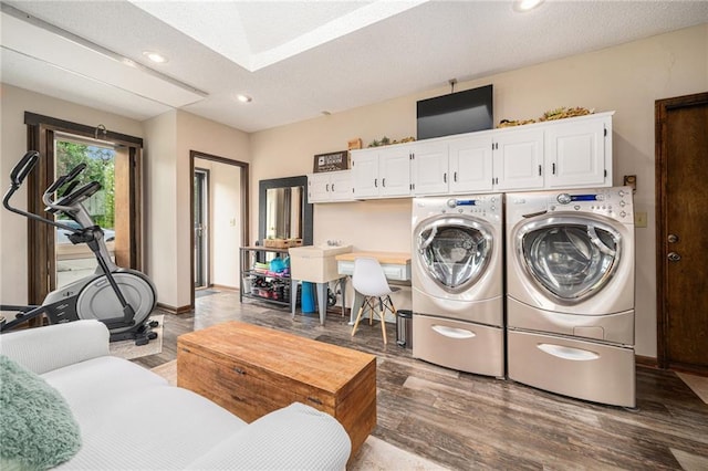2018 Park Ln, Smithville, MO 64089 - washroom with separate washer and dryer, cabinet space, recessed lighting, wood finished floors, and a skylight