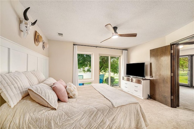 2018 Park Ln, Smithville, MO 64089 - bedroom featuring carpet, a textured ceiling, ceiling fan, a wainscoted wall, and a decorative wall