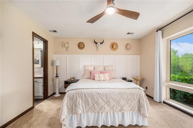 2018 Park Ln, Smithville, MO 64089 - bedroom with light carpet, a ceiling fan, a textured ceiling, and a decorative wall