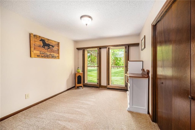 2018 Park Ln, Smithville, MO 64089 - spare room with light colored carpet, a textured ceiling, and baseboards