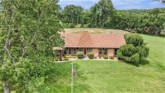 2018 Park Ln, Smithville, MO 64089 - ranch-style house with a front yard, roof with shingles, and a chimney
